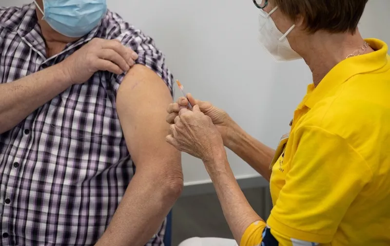 A man is vaccinated by a medical healthcare worker, holding and pressing the syringe jab to the arm. New XL Vaccination center against Covd coronavirus in Helmond from the Municipal Health Service GGD, Dutch Gemeentelijke Gezondheidsdienst, a decentralised public health care organisation. The new vaccination center, a converted factory - warehouse is part of the Dutch vaccination program against COVID-19, the system invites people to get the jab with a target for everyone over 18 to be invited in 2021. The new facility in Helmond opened on Saturday 24 April 2021, offering the BioNTech Pfizer vaccine with the capability to vaccinate over 5000 people per day in the 13+ lines. The Netherlands is opening more mega centers trying to ramp up the immunization process of the population to provide safety against the spread of the pandemic. Helmond, The Netherlands on April 24, 2021
COVID Vaccination In The Netherlands, Helmond - 24 Apr 2021,Image: 607902754, License: Rights-managed, Restrictions: , Model Release: no, Credit line: Profimedia