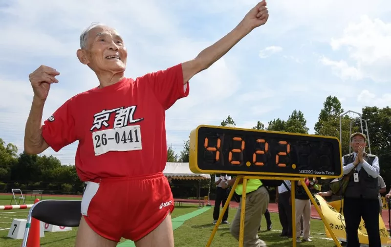 TOPSHOTS
Hidekichi Miyazaki (in red), 105, imitates the pose of Usain Bolt after running with other competitors over eighty years of age during a 100-metre-dash in the Kyoto Masters Autumn Competiton in Kyoto, western Japan, on September 23, 2015. Miyazaki was authorised as the oldest sprinter who competed in a 100-metre-dash by the Guinness World Records.      AFP PHOTO / Toru YAMANAKA