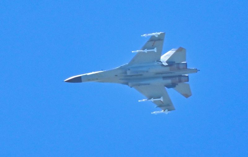 A Chinese military jet flies over Pingtan island, one of mainland China's closest point from Taiwan, in Fujian province on August 5, 2022. - Taiwan blasted its "evil neighbour next door" on August 5 after China encircled the island with a series of huge military drills that were condemned by the United States and other Western allies. (Photo by Hector RETAMAL / AFP)