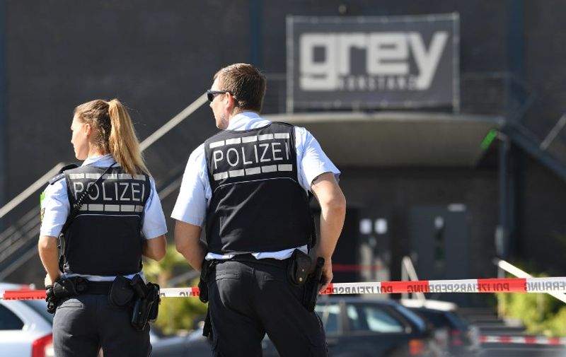 Police stand in front of the disco Club Grey in the southern German town of Konstanz, where a gunman opened fire, killing one and wounding four people before being shot by police, on July 30, 2017. 
The 34-year-old attacker "was critically injured in a shootout with police officers as he left the disco, and later succumbed to his wounds in hospital," police said in a statement.
 / AFP PHOTO / dpa / Felix Kästle / Germany OUT