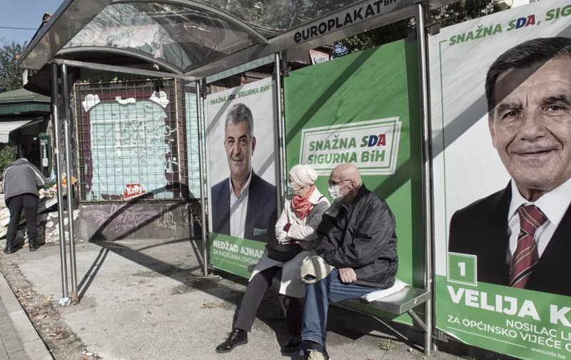 An elderly couple is sitting at a bus stop in Sarajevo, which is plastered with pre-election posters of the SDA party, otherwise known as the Bosniak Muslim Party. They are not really interested in the posters behind them.



Local elections 2020 in Bosnia and Herzegovina

These local elections come at a time of the Covid-19 pandemic, which has seen a sharp rise in the number of people infected every day in Bosnia since early October. After the heinous scandals over the procurement of medical equipment during the first wave of the pandemic in Bosnia and Herzegovina, the question is whether the voters will punish the political parties whose members were involved in the mentioned scandals. Because of Covid-19, pre-election rallies are banned or restricted with the approval of gatherings of very few people. The favorites, as always during the last 25 years since the end of the war in Bosnia, are parties with nationalist signs of the three constituent peoples in Bosnia and Herzegovina (Bosniaks, Serbs and Croats). Still, there is hope that the center's civic parties in conjunction with left-wing parties could make a surprise. We will see that after November 15, 2020.
//HADROVICAHMED_1750.13176/2010211713/Credit:Ahmed Hadrovic/SIPA/2010211715,Image: 564872134, License: Rights-managed, Restrictions: , Model Release: no