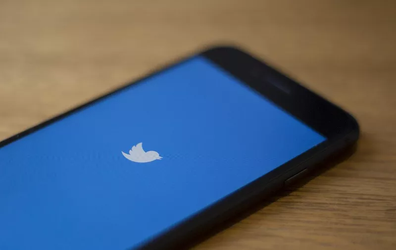 (FILES) In this file photo taken on July 10, 2019 the Twitter logo is seen on a phone in this photo illustration in Washington, DC. - Twitter said on October 30, 2019 that it would stop accepting political advertising globally on its platform, responding to growing concerns over misinformation from politicians on social media. (Photo by Alastair Pike / AFP)