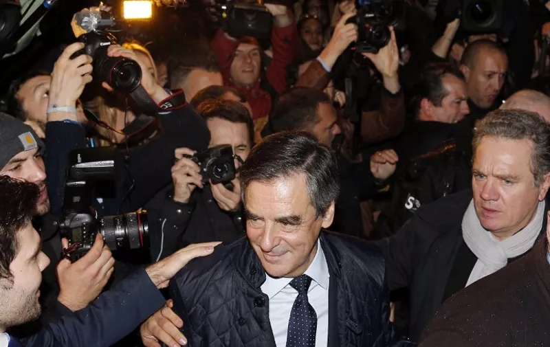 Former French Prime minister and candidate for the French right-wing presidential primary Francois Fillon arrives at his campaign headquarters after the vote's first round, on November 20, 2016 in Paris. 
Francois Fillon took a commanding lead in the two-round primary that is widely expected to decide the country's next leader. In a major upset, Fillon had more than 43 percent of the vote to 26.7 percent for former prime minister Alain Juppe and just under 23 percent for Nicolas Sarkozy, according to the official tallies.
 / AFP PHOTO / POOL / GONZALO FUENTES