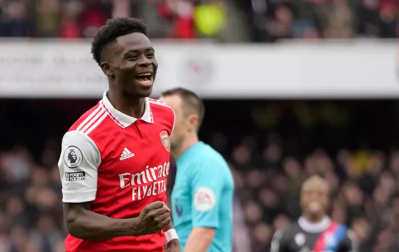 Arsenal's Bukayo Saka celebrates after scoring his side's fourth goal during the English Premier League soccer match between Arsenal and Crystal Palace at Emirates stadium in London, Sunday, March 19, 2023. (AP Photo/Kirsty Wigglesworth)