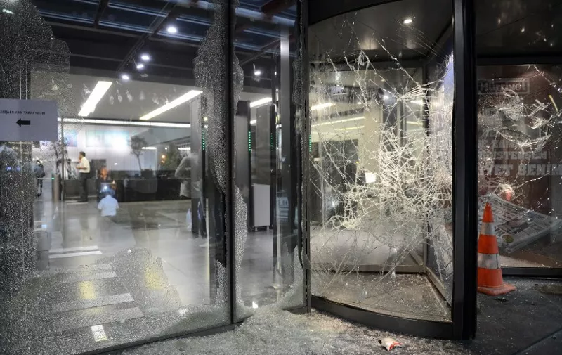 This photo taken on September 8, 2015 shows broken windows of the headquarters of the Hurriyet newspaper on September 8, 2015, in Istanbul's Bagcilar district, after an attack. Supporters of Turkey's ruling Justice and Development Party (AKP) stormed the headquarters of the Hurriyet newspaper today in Istanbul after accusing the daily of misquoting President Recep Tayyip Erdogan. The attack on the newspaper comes amid growing concern over press freedoms in Turkey and the use of the courts by the president to pursue journalists who criticise him. AFP PHOTO / HURRIYET DAILY