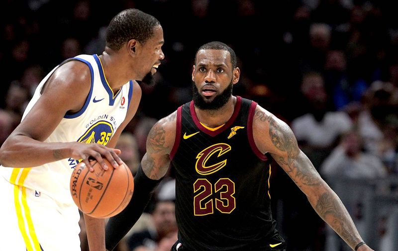 Cleveland Cavaliers forward LeBron James defends Golden State Warriors forward Kevin Durant in the third quarter Monday, Jan. 15, 2018 in Cleveland, Ohio. The Cavaliers lost to the Warriors 118-108. (Leah Klafczynski/Akron Beacon Journal/TNS)