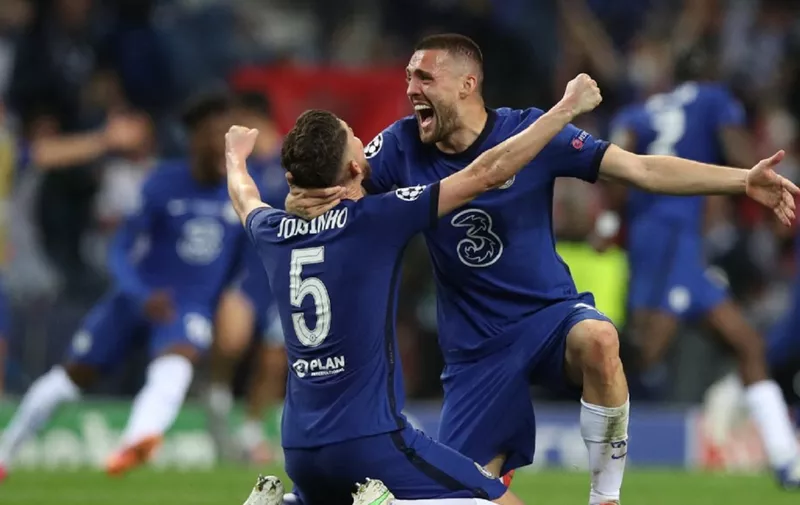Chelsea's Italian midfielder Jorginho (L) and Chelsea's Croatian midfielder Mateo Kovacic celebrate after winning the UEFA Champions League final football match between Manchester City and Chelsea FC at the Dragao stadium in Porto on May 29, 2021. (Photo by Jose Coelho / POOL / AFP)