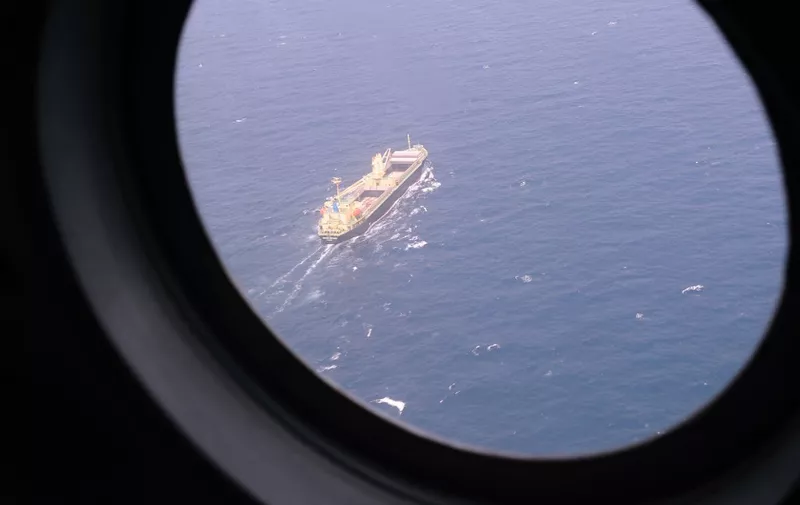 This aerial picture taken from aboard a Vietnamese Air Force Russian-made MI-171 helicopter shows a ship sailing below during a search flight some 200 km over the southern Vietnamese waters off Vietnam's island Phu Quoc on March 11, 2014 as part of continued efforts aimed at finding traces of the missing Malaysia Airlines MH370. Malaysian police said on March 11 one of two suspect passengers who boarded a missing passenger jet was an Iranian illegal immigrant, as relatives of some of the 239 people on board said they were losing hope for a miracle.     AFP PHOTO / HOANG DINH NAM (Photo by HOANG DINH NAM / AFP)