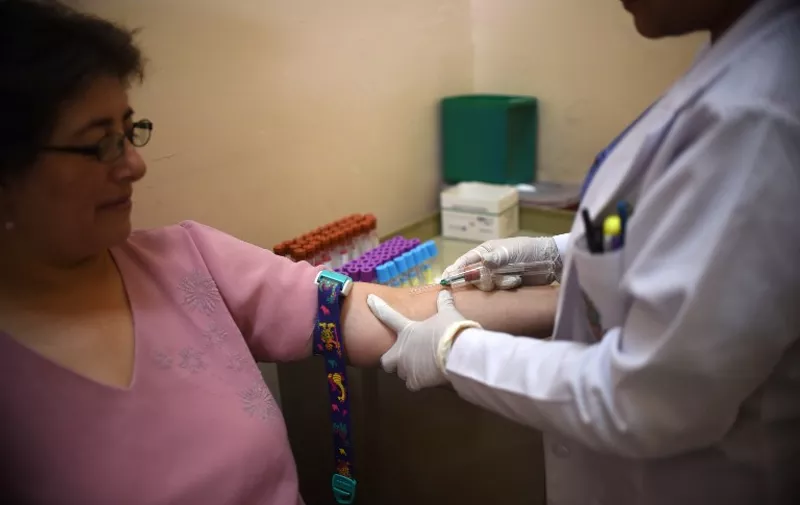 A paramedic takes a blood sample from a pregnant women at the maternity of the Guatemalan Social Security Institute (IGSS) in Guatemala City on February 2, 2016. Guatemala increased the monitoring of pregnant women because of the risk of infection by Zika virus. World health officials mobilized with emergency response plans and funding pleas Tuesday as fears grow that the Zika virus, blamed for a surge in the number of brain-damaged babies, could spread globally and threaten the Summer Olympics. AFP PHOTO Johan ORDONEZ / AFP / JOHAN ORDONEZ