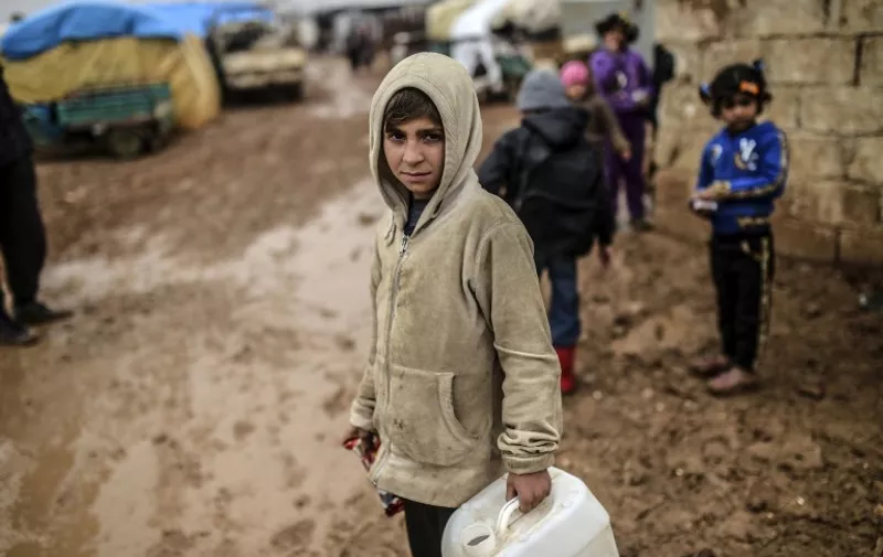A child is pictured as refugees arrive at the Turkish border crossing gate as Syrians fleeing the northern embattled city of Aleppo wait on February 6, 2016 in Bab-Al Salam, near the city of Azaz, northern Syria.
Thousands of Syrians were braving cold and rain at the Turkish border Saturday after fleeing a Russian-backed regime offensive on Aleppo that threatens a fresh humanitarian disaster in the country's second city. Around 40,000 civilians have fled their homes over the regime offensive, according to the Syrian Observatory for Human Rights monitor. / AFP / BULENT KILIC