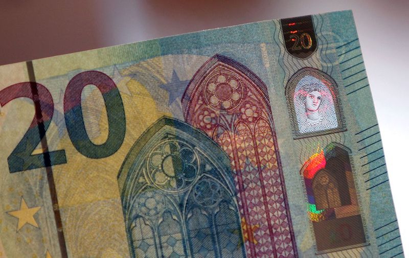 A detail of a new 20 Euro note is seen in Frankfurt am Main, western Germany, on March 4, 2015. According to the German Central Bank Bundesbank, the new banknote containing an additional innovative security feature, the portrait window in the hologram, will be issued for retailers and consumers on November 25, 2015.     AFP PHOTO / DANIEL ROLAND (Photo by DANIEL ROLAND / AFP)