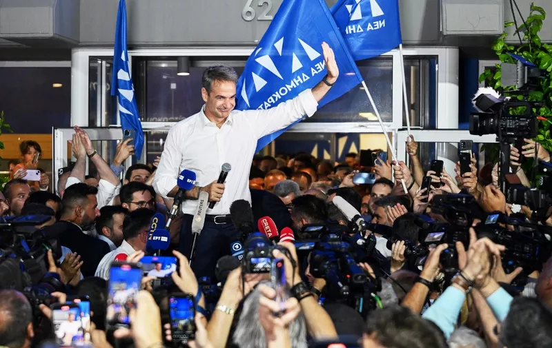 Leader of Greece's conservative party New Democracy Kyriakos Mitsotakis waves to supporters during an election evening event after general elections in central Athens, on June 25, 2023. Greece's Conservative leader won the country's national elections on June 25 with a clear majority, clinching a second term with what he called a "strong mandate" that would allow his party to govern alone. In an election one month prior, his party fell short of five seats in parliament to be able to form a single-party government. (Photo by ARIS MESSINIS / AFP)