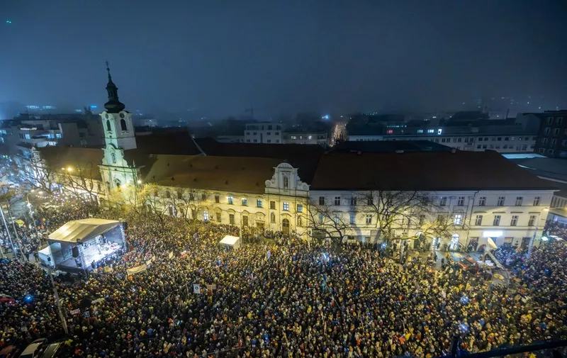 People take part in a demonstration to protest against the government's plan to close a special prosecutor's office, in Bratislava, Slovakia, on January 18, 2024. Several thousand people took to the streets in Bratislava on January 18, 2024 to protest against the criminal code reforms planned by Slovakia's government, criticised by the European Union and the opposition alike. (Photo by TOMAS BENEDIKOVIC / AFP)