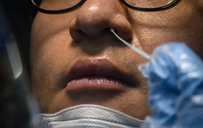 A man recieves a COVID-19 novel coronavirus test swab at a testing booth outside the Yangji hospital in Seoul on March 17, 2020. A South Korean hospital has introduced "phone booth"-style coronavirus testing facilities that avoid medical staff having to touch patients directly and cut down disinfection times., Image: 507151029, License: Rights-managed, Restrictions: , Model Release: no, Credit line: Ed JONES / AFP / Profimedia