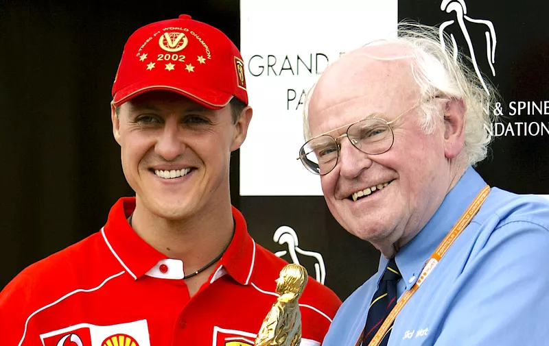 INDIANAPOLIS - SEPTEMBER 28:  Ferrari driver Michael Schumacher of Germany and Formula One Doctor Sid Watkins with the Bernie Award during the second practice for the US Formula One Grand Prix held on September 28, 2002 at the Indianapolis Motorspeedway, in Indianapolis, USA. (Photo by Getty Images)