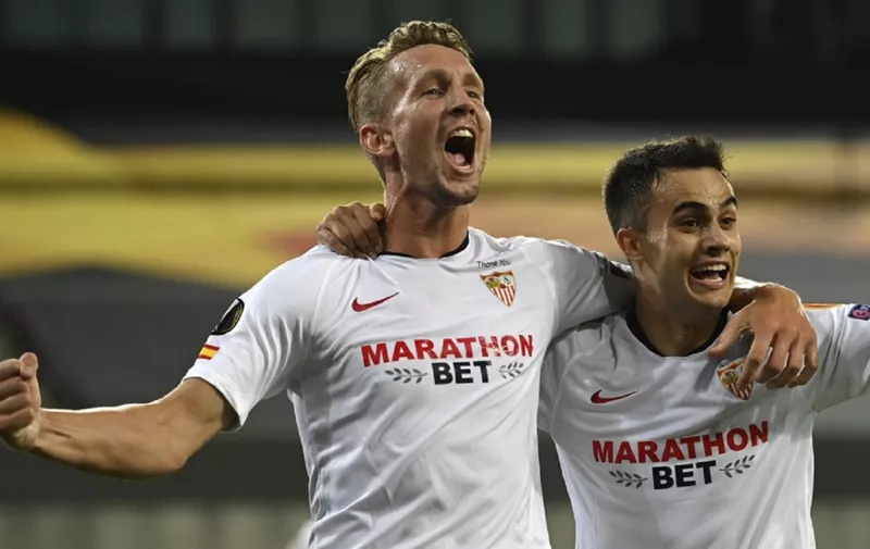 Sevilla's Dutch forward Luuk De Jong (L) celebrates scoring with his team-mate Sevilla's Spanish defender Sergio Reguilon during the UEFA Europa League semi-final football match Sevilla v Manchester United on August 16, 2020 in Cologne, western Germany. (Photo by Ina Fassbender / POOL / AFP)
