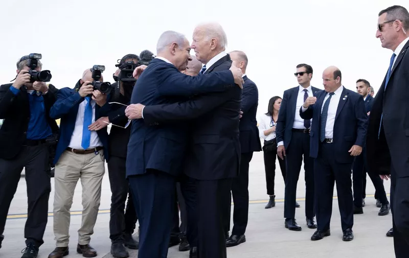 Israel Prime Minister Benjamin Netanyahu (L) hugs US President Joe Biden upon his arrival at Tel Aviv's Ben Gurion airport on October 18, 2023, amid the ongoing battles between Israel and the Palestinian group Hamas. Biden landed in Israel on October 18, on a solidarity visit following Hamas attacks that have led to major Israeli reprisals. (Photo by Brendan Smialowski / AFP)