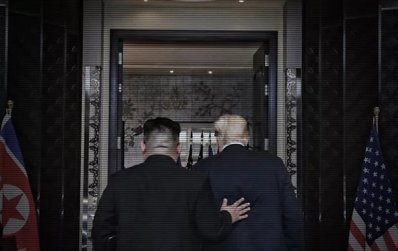 This handout photo taken on June 12, 2018 and released by The Straits Times shows US President Donald Trump (R) and North Korea's leader Kim Jong Un (L) leaving after a signing ceremony during their historic US-North Korea summit, at the Capella Hotel on Sentosa island in Singapore.
Donald Trump and Kim Jong Un became on June 12 the first sitting US and North Korean leaders to meet, shake hands and negotiate to end a decades-old nuclear stand-off. / AFP PHOTO / THE STRAITS TIMES / Kevin LIM /  - Singapore OUT / RESTRICTED TO EDITORIAL USE - MANDATORY CREDIT "AFP PHOTO / The Straits Times / Kevin LIM" - NO MARKETING NO ADVERTISING CAMPAIGNS - DISTRIBUTED AS A SERVICE TO CLIENTS - NO ARCHIVES