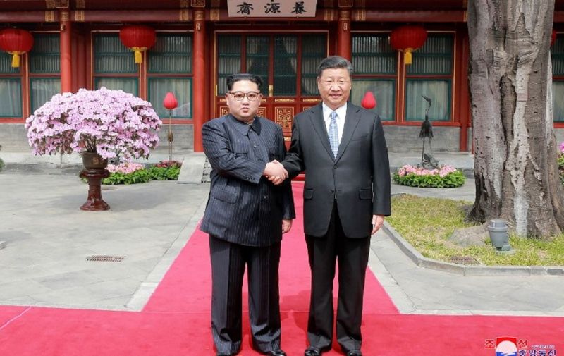 This picture from North Korea's official Korean Central News Agency (KCNA) taken on March 27, 2018 and released on March 28, 2018 shows China's President Xi Jinping (R) shaking hands with North Korean leader Kim Jong Un in Beijing.
North Korean leader Kim Jong Un was treated to a lavish welcome by Chinese President Xi Jinping during a secretive trip to Beijing as both sides seek to repair frayed ties ahead of landmark summits with Seoul and Washington.  / AFP PHOTO / KCNA VIA KNS / - / South Korea OUT / REPUBLIC OF KOREA OUT   ---EDITORS NOTE--- RESTRICTED TO EDITORIAL USE - MANDATORY CREDIT "AFP PHOTO/KCNA VIA KNS" - NO MARKETING NO ADVERTISING CAMPAIGNS - DISTRIBUTED AS A SERVICE TO CLIENTS
THIS PICTURE WAS MADE AVAILABLE BY A THIRD PARTY. AFP CAN NOT INDEPENDENTLY VERIFY THE AUTHENTICITY, LOCATION, DATE AND CONTENT OF THIS IMAGE. THIS PHOTO IS DISTRIBUTED EXACTLY AS RECEIVED BY AFP.  /
