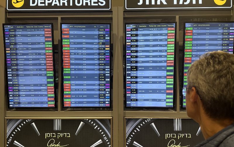 TEL AVIV, ISRAEL - OCTOBER 8: A man looks at the board showing departure schedules at Ben Gurion Airport, Israel's only international airport, after many flights from abroad are cancelled due to the attacks launched by Palestinian factions in Tel Aviv, Israel on October 8, 2023. Turgut Alp Boyraz / Anadolu Agency (Photo by Turgut Alp Boyraz / ANADOLU AGENCY / Anadolu Agency via AFP)