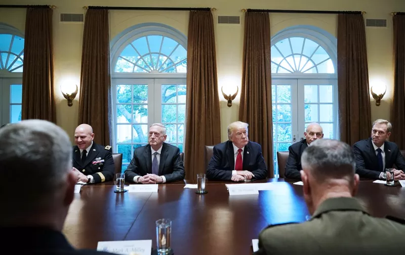US President Donald Trump, flanked by Defense Secretary James Mattis (L), and Chief of Staff John Kelly (R), hold a meeting with senior military leaders in the Cabinet Room of the White House on October 5, 2017. (Photo by Mandel NGAN / AFP)