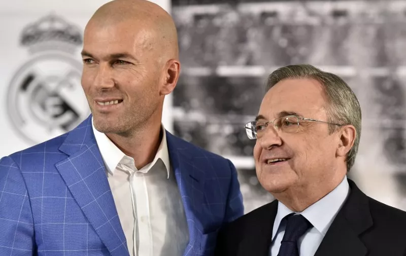 Real Madrid's new French coach Zinedine Zidane (L) poses with Real Madrid's president Florentino Perez after a statement at the Santiago Bernabeu stadium in Madrid on January 4, 2016. Rafael Benitez's unhappy reign in charge of Real Madrid came to an end after just seven months and 25 games when he was sacked and replaced by club legend Zinedine Zidane today. AFP PHOTO/ GERARD JULIEN / AFP / GERARD JULIEN