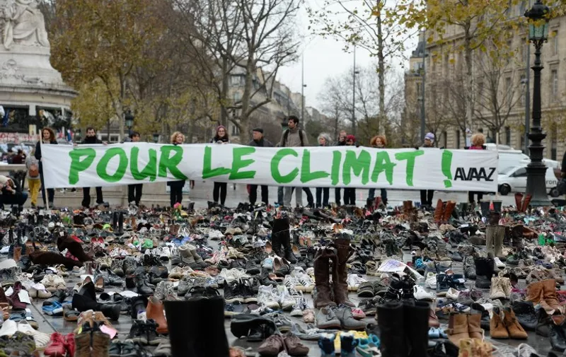 TOPSHOTS
The Place de la Republique is covered in hundreds of pairs of shoes on November 29, 2015 in downtown Paris, as part of a symbolic and peaceful rally called by the NGO Avaaz "Paris sets off for climate" within the UN conference on climate change COP21, as an attempt to get round the French authorities' ban on public gatherings. Paris has extended a ban on public gatherings introduced after the terror attacks in the French capital until November 30, the start of UN climate talks, where some 150 leaders will be tasked with reaching the first truly universal climate pact. The banner reads "(Paris sets off) for climate". AFP PHOTO / MIGUEL MEDINA / AFP / MIGUEL MEDINA