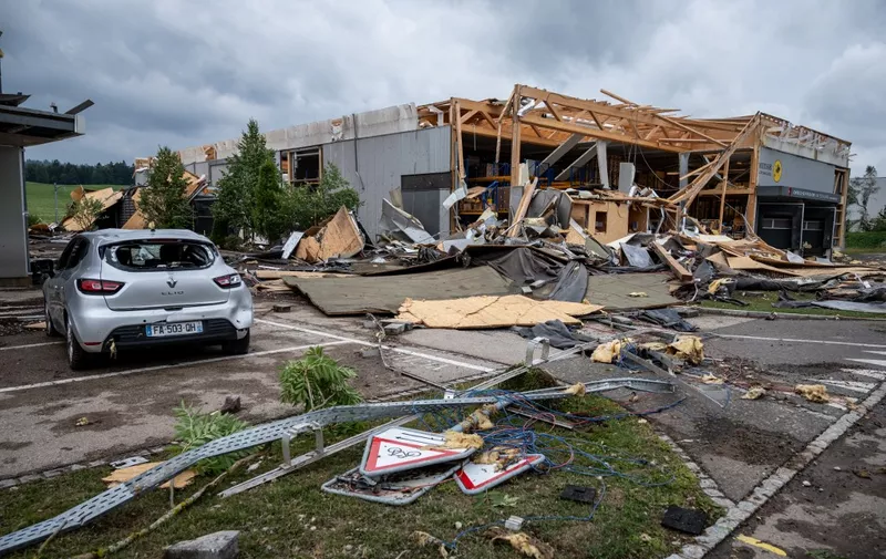A picture taken on July 24, 2023 shows a damaged building, a few hours after a violent storm hit the aera in Le Cret-du-Locle near La Chaux-de-Fonds, western Switzerland. According to local media, at least one person was killed, when a crane fell. (Photo by Fabrice COFFRINI / AFP)