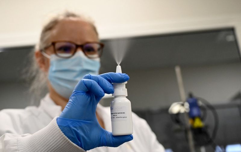A laboratory worker tests a nasal spray at the Pharma and Beauty factory in Saint-Chamas, southeastern France, on January 21, 2021. - The Pharma and Beauty company has developped a nasal spray based on ionised water, known for its antimicrobial properties, which eliminates 99% of the viral load. (Photo by NICOLAS TUCAT / AFP)