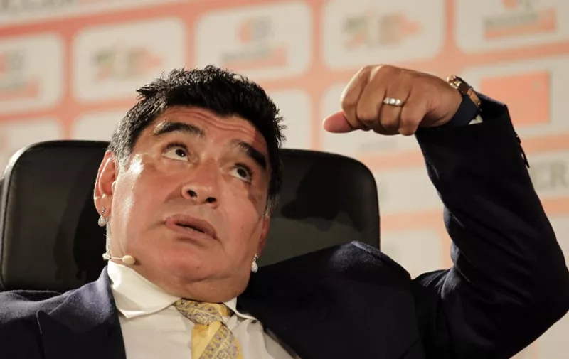 Argentina's legendary ex-footballer Diego Maradona gestures as he speaks during the Soccerex Asian Forum on developing the business of football in Asia on May 4, 2015 at the King Hussein Convention Center in the Dead Sea resort of Shuneh, west of the capital Amman.   AFP PHOTO / 