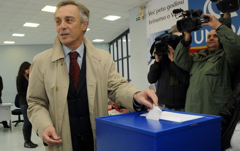 Presidential candidate Miodrag Lekic casts his ballot at a polling station in Podgorica on April 7, 2013. Montenegro began voting Sunday in a presidential election tipped to give the incumbent, Filip Vujanovic, a third mandate that would cement the ruling coalition's grip on power in the economically struggling Balkan state aiming to join the EU. AFP PHOTO / SAVO PRELEVIC (Photo by SAVO PRELEVIC / AFP)