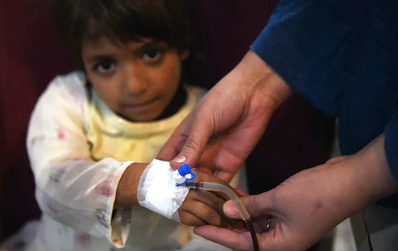 A Pakistani Thalassaemia patient receives blood at a treatment center in Peshawar on December 4, 2014.  Ten Pakistani children, from the cities of Islamabad, Rawalpindi and Lahore, have been infected with HIV after receiving tainted blood transfusions, officials said, in a "shocking" case highlighting the abysmal state of blood screening in the country. Dr Yasmin Rashid, secretary general of the Thalassaemia Federation of Pakistan,said that it was hard to pinpoint at this stage which blood banks were the culprits.   AFP PHOTO/A MAJEED