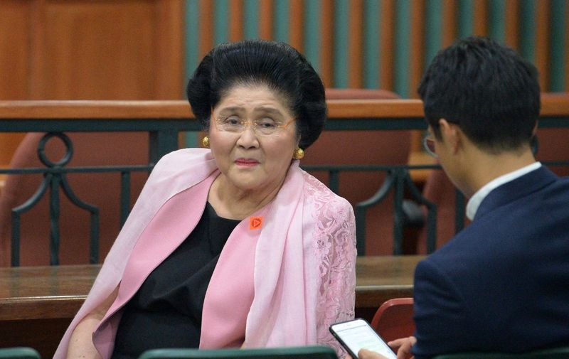 Philippines' former first lady Imelda Marcos (L) waits for a release order from the graft court following her hearing at the graft court in Manila on November 16, 2018. (Photo by Ted ALJIBE / AFP)