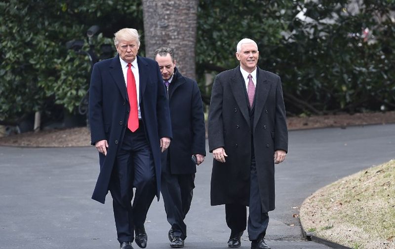 US President Donald Trump, White House Chief of Staff Reince Priebus and Vice President Mike Pence walk to greet Harley Davidson executives and union representatives on the South Lawn of the White House in Washington, DC, on February 2, 2017 prior to a luncheon with them. / AFP PHOTO / NICHOLAS KAMM