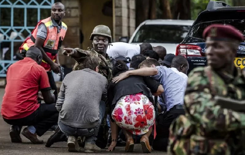 Special forces protect people at the scene of an explosion at a hotel complex in Nairobi's Westlands suburb on January 15, 2019, in Kenya. - A huge blast followed by a gun battle rocked an upmarket hotel and office complex in Nairobi on January 15, 2018, causing casualties, in an attack claimed by the Al-Qaeda-linked Shabaab Islamist group. (Photo by Luis TATO / AFP)