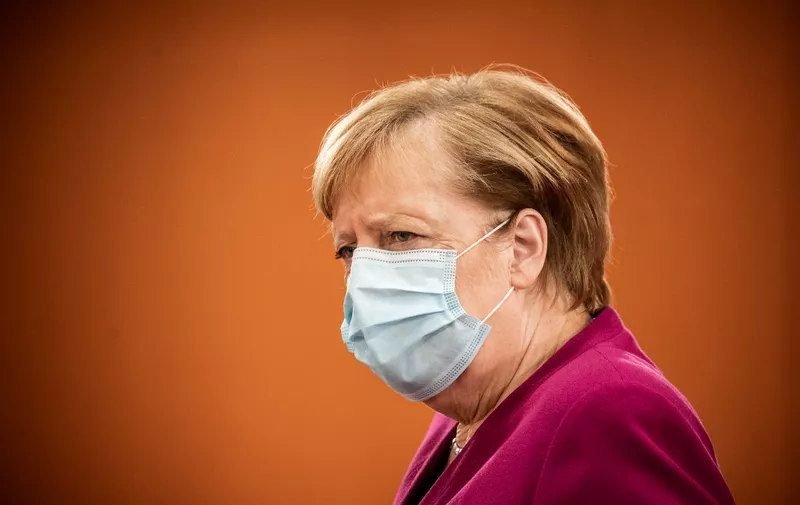 German Chancellor Angela Merkel wearing a face mask frowns as she arrives to attend the weekly cabinet meeting of the German government at the Chancellery in Berlin, on October 14, 2020. (Photo by Michael Kappeler / POOL / AFP)