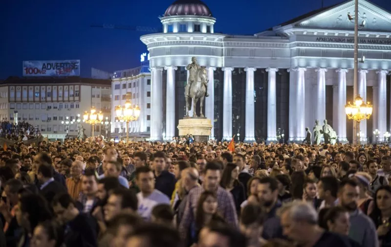 Protesters walk and shout slogans in central Skopje on April 15, 2016, during a protest against the president's shock decision to halt probes into more than 50 public figures embroiled in a wire-tapping scandal. 
Protesters took to the streets of Skopje for the fourth night in a row on April 15, 2016, after Macedonia confirmed snap polls for June as the country grapples with a bitter political crisis. Thousands of people, mainly SDSM supporters, took to the streets again demanding President Gjorge Ivanov either revoke his decision or resign, as well as calling for the election to be postponed. / AFP PHOTO / Robert ATANASOVSKI