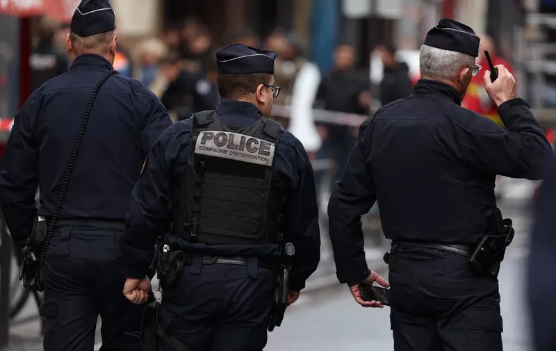 French police secure the street after several shots were fired along rue d'Enghien in the 10th arrondissement, in Paris on December 23, 2022. - Two people were killed and four injured in a shooting in central Paris on December 23, 2022, police and prosecutors said, adding that the shooter, in his 60s, had been arrested. The motives of the gunman remain unclear, with two of the four injured left in a serious condition, the French officials said. (Photo by Thomas SAMSON / AFP)
