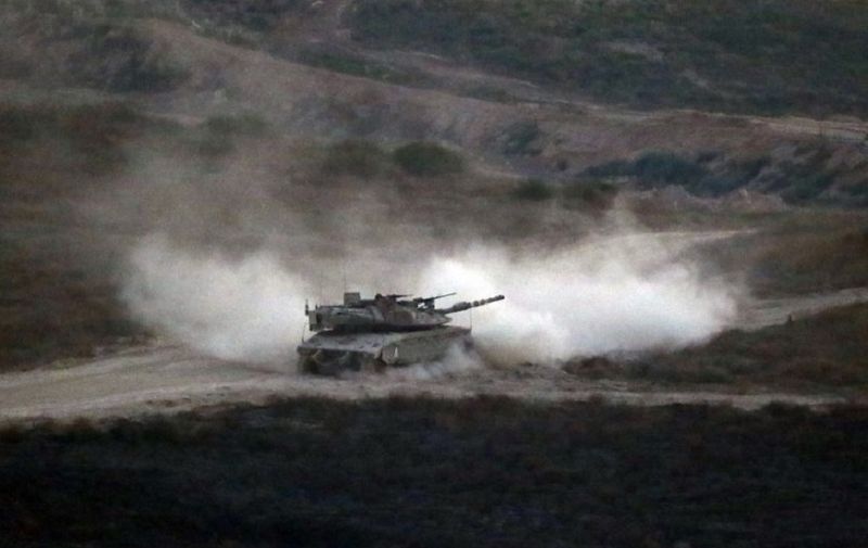 An Israeli army tank patrols along the border between Israel and the Gaza Strip on May 29, 2018.
Israel said it struck dozens of militant targets in the Gaza Strip today in response to a barrage of mortar and rocket fire from the Palestinian enclave in the most severe military flare-up since a 2014 war. / AFP PHOTO / Jack GUEZ