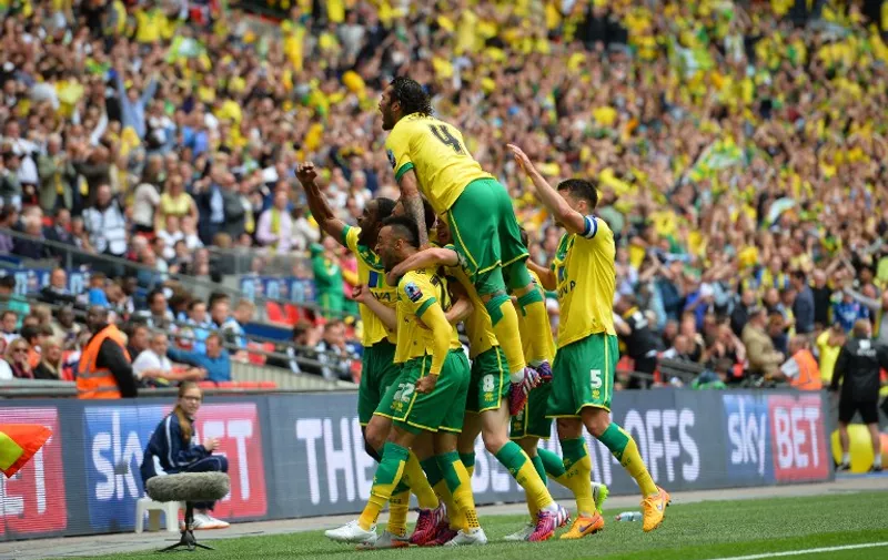 Norwich City players celebrate their second goal scored by Norwich City's English midfielder Nathan Redmond (2L) during the English Championship play off final football match between Middlesbrough and Norwich City at Wembley Stadium in London on May 25, 2015. AFP PHOTO / GLYN KIRK

NOT FOR MARKETING OR ADVERTISING USE / RESTRICTED TO EDITORIAL USE
