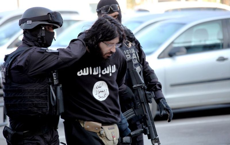 This handout  photo obtained from Bosnia and Herzegovina's State Agency for Investigations and Protection (SIPA) on April 15, 2015 shows SIPA officers conducting an actual arrest in the greater Sarajevo area, on April 15, 2015. Police in Bosnia arrested a man on terrorism charges for allegedly meeting with Islamic State jihadists in Syria. The suspect, named as Kenan Krso, was suspected of "several activities linked with terrorism," a spokesman for the public prosecutor's office told reporters.  RESTRICTED TO EDITORIAL USE - MANDATORY CREDIT  " AFP PHOTO / BOSNIA AND HERZEGOVINA STATE AGENCY FOR INVESTIGATION AND PROTECTION. "  -  NO MARKETING NO ADVERTISING CAMPAIGNS   -   DISTRIBUTED AS A SERVICE TO CLIENTS  / AFP PHOTO / SIPA / HO