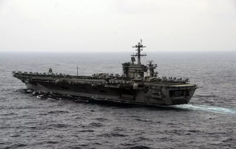This US Navy photo obtained November 4, 2015 shows the aircraft carrier USS Theodore Roosevelt (CVN 71)as it transits the South China Sea on October 29, 2015. Theodore Roosevelt is operating in the US 7th Fleet area of operations as part of a worldwide deployment en route to its new homeport in San Diego to complete a three-carrier homeport shift.  US Defense Secretary Ashton Carter said he would visit the American aircraft carrier in the South China Sea on November 5, 2015 as US-Chinese tensions over the waterway escalate. Speaking after a regional summit November 4, 2015, Carter said he would fly out to the nuclear-powered USS Theodore Roosevelt, which "is conducting routine operations while transiting the South China Sea".  AFP PHOTO/US NAVY/ Specialist 3rd Class Anthony N. Hilkowski  = RESTRICTED TO EDITORIAL USE - MANDATORY CREDIT "AFP PHOTO /US NAVY/ Specialist 3rd Class Anthony N. Hilkowski " - NO MARKETING NO ADVERTISING CAMPAIGNS - DISTRIBUTED AS A SERVICE TO CLIENTS =
