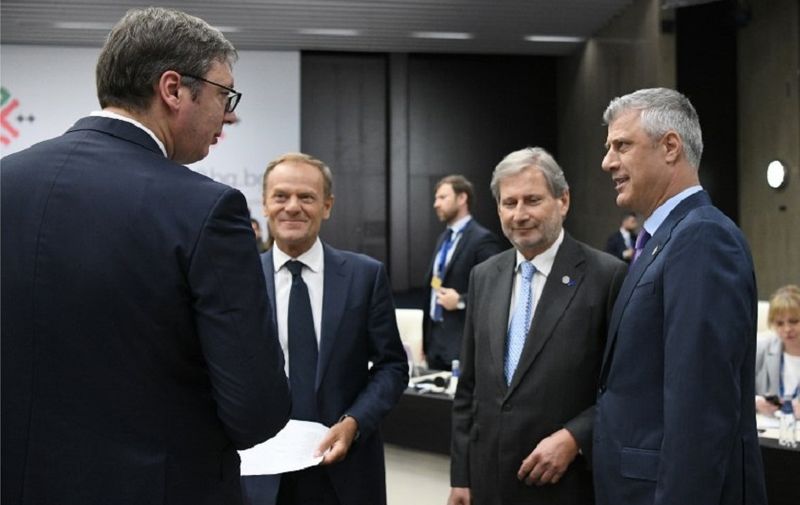 Serbian President Aleksander Vucic (L) speaks with Kosovan President Hashim Thaci next to European Commissioner for European Neighborhood Policy Johannes Hahn (2R) and European Council President Donald Tusk during the EU-Western Balkans Summit in Sofia on May 17, 2018.
European Union leaders meet their Balkan counterparts to hold out the promise of closer links to counter Russian influence, while steering clear of openly offering them membership. / AFP PHOTO / POOL / Dimitar DILKOFF
