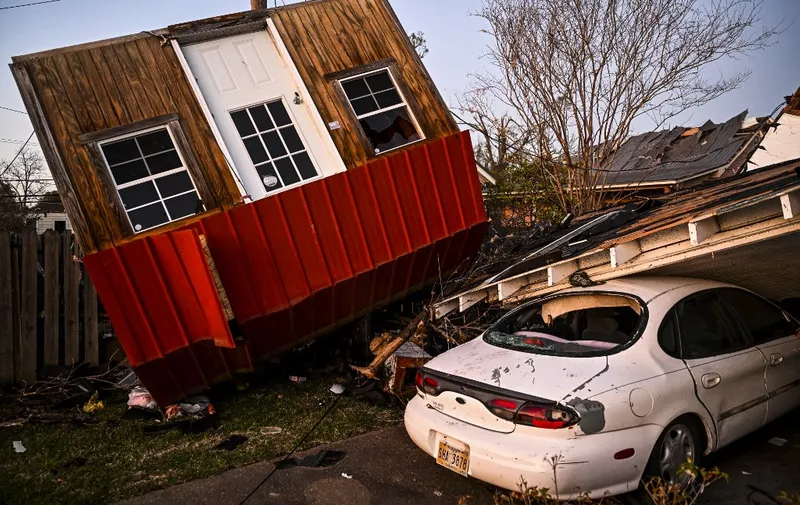 The remains of crushed house and cars are seen in Rolling Fork, Mississippi, on March 25, 2023, after a tornado touched down in the area. - At least 25 people were killed by devastating tornadoes that ripped across the southern US state of Mississippi, tearing off roofs, smashing cars and flattening entire neighborhoods, with the region readying for more severe weather Sunday.
The powerful weather system, accompanied by thunderstorms and driving rain, cut a path of more than 100 miles (60 kilometers) across the state late March 24, 2023, slamming several towns along the way. (Photo by CHANDAN KHANNA / AFP)