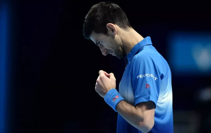 Serbia's Novak Djokovic wins a point against Spain's Rafael Nadal during the men's singles semi-final match on day seven of the ATP World Tour Finals tennis tournament in London on November 21, 2015. 
AFP PHOTO / LEON NEAL / AFP / LEON NEAL