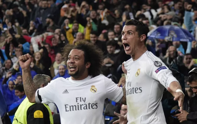 Real Madrid's Portuguese forward Cristiano Ronaldo (R) and Real Madrid's Brazilian defender Marcelo celebrate after scoring a goal during the Champions League quarter-final second leg football match Real Madrid vs Wolfsburg at the Santiago Bernabeu stadium in Madrid on April 12, 2016. / AFP PHOTO / JAVIER SORIANO