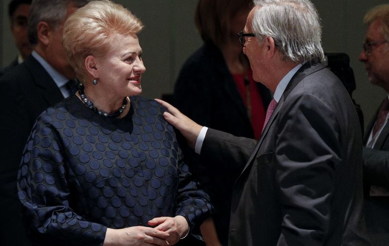 Lithuania's President Dalia Grybauskaite (L) speaks with President of the European Commission Jean-Claude Juncker prior to attending a working dinner during a European Council Summit at The Europa Building in Brussels, on June 30, 2019. - Deadlocked EU leaders meet for a rare weekend summit seeking to fill senior European positions and settle a battle that has split key allies France and Germany. (Photo by GEOFFROY VAN DER HASSELT / POOL / AFP)