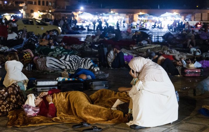 Residents stay out at a square in Marrakesh on September 9, 2023, after an earthquake. A powerful earthquake that struck Morocco on September 8 night has killed at least 632 people and injured 329 others, according to an updated interior ministry toll. (Photo by FADEL SENNA / AFP)