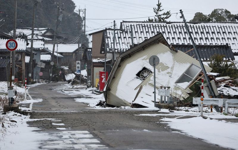 A photo shows a disaster-stricken area damaged by a massive earthquake in Nanao City, Ishikawa Prefecture on January 25, 2024. The strong earthquake of magnitude 7.6 hit the Noto peninsula of Ishikawa Prefecture, central Japanese main island, on Jan. 1st. The affected area is covered with snow.( The Yomiuri Shimbun ) (Photo by Fuminori Ogane / Yomiuri / The Yomiuri Shimbun via AFP)