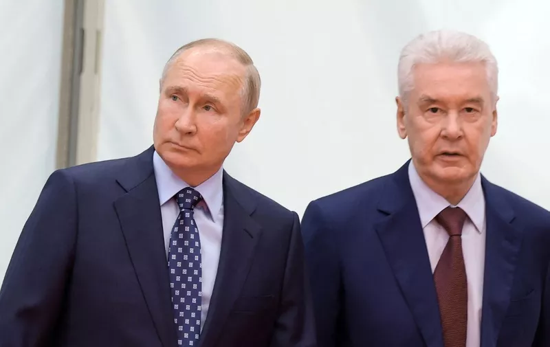 In this pool image distributed by Russian state owned agency Sputnik and taken on August 17, 2023, Russia's President Vladimir Putin (L) and Moscow's mayor Sergey Sobyanin attend a ceremony to launch the Line D3 of the Moscow Central Diametres (MCD) suburban railway network in Moscow. (Photo by Mikhail KLIMENTYEV / POOL / AFP)